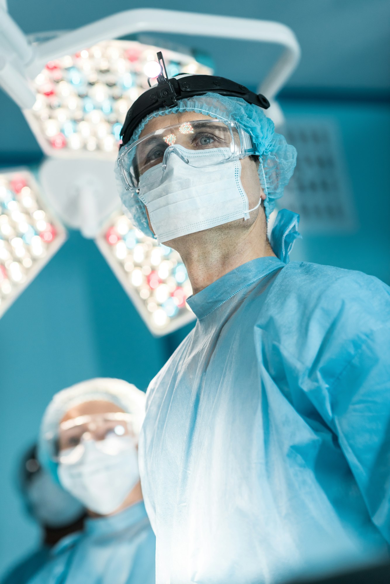 bottom view of surgeon in medical mask looking away